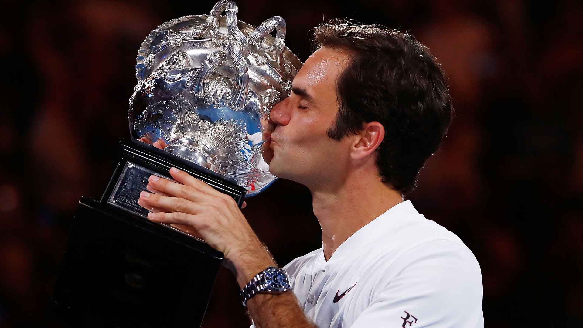 Roger Federer celebrates becoming the first man in tennis history to win 20 Grand Slam championship trophies on Sunday at the Australian Open.