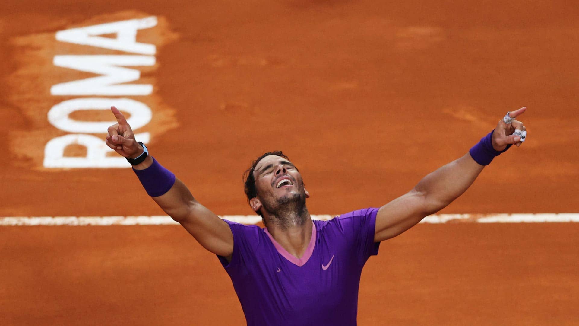 Rafael Nadal celebrates winning the 2021 Rome final against Novak Djokovic.